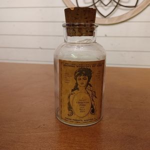 Vintage bird food bottle